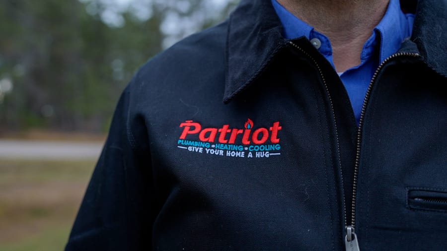 Professional plumber from Patriot Plumbing prepared for clogged toilet repair.