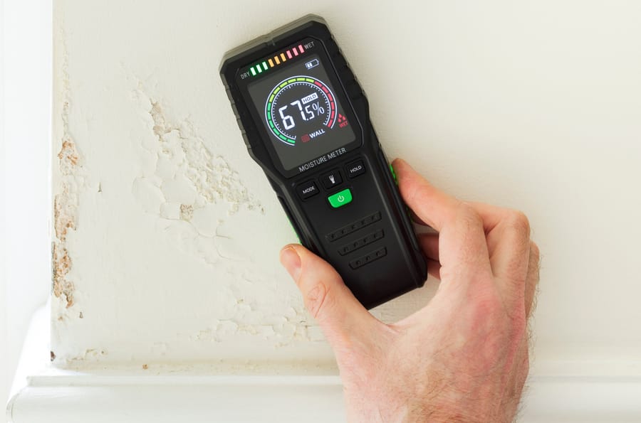 Moisture detection device identifying hidden water intrusion inside a residential wall.