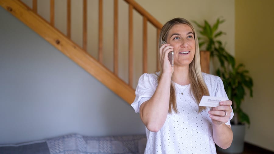 Homeowner speaking with a Patriot Plumbing professional about sewer pipe repair inside a Wenatchee home.